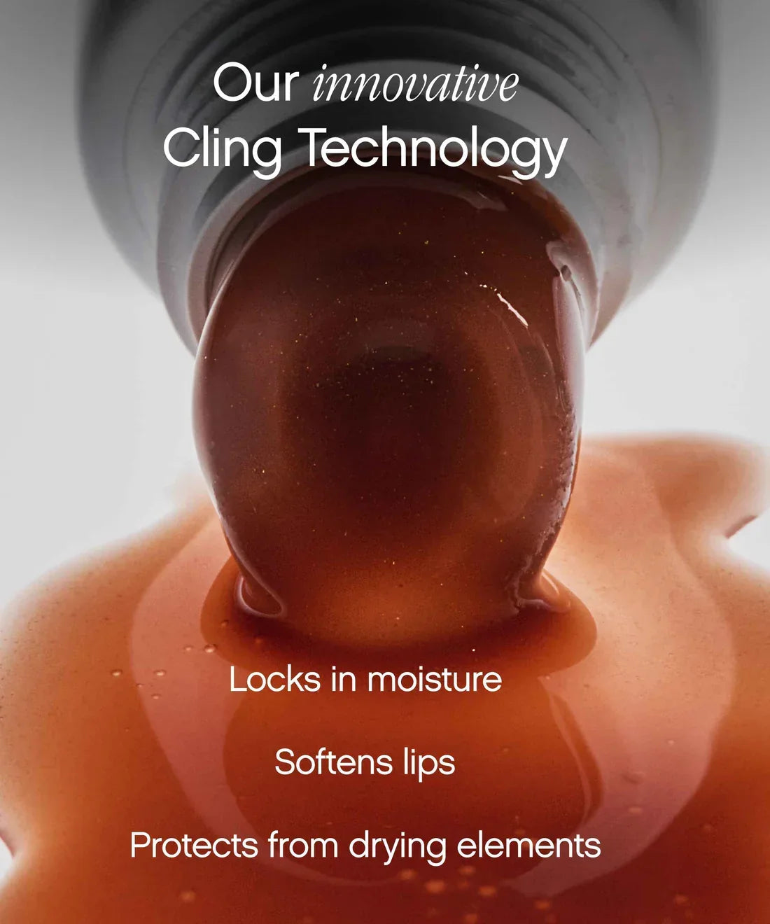 Glossy amber dollop of Topicals Slick Salve Papaya lip balm dripping over skin, illustrating the cling technology of this hydrating lip balm.